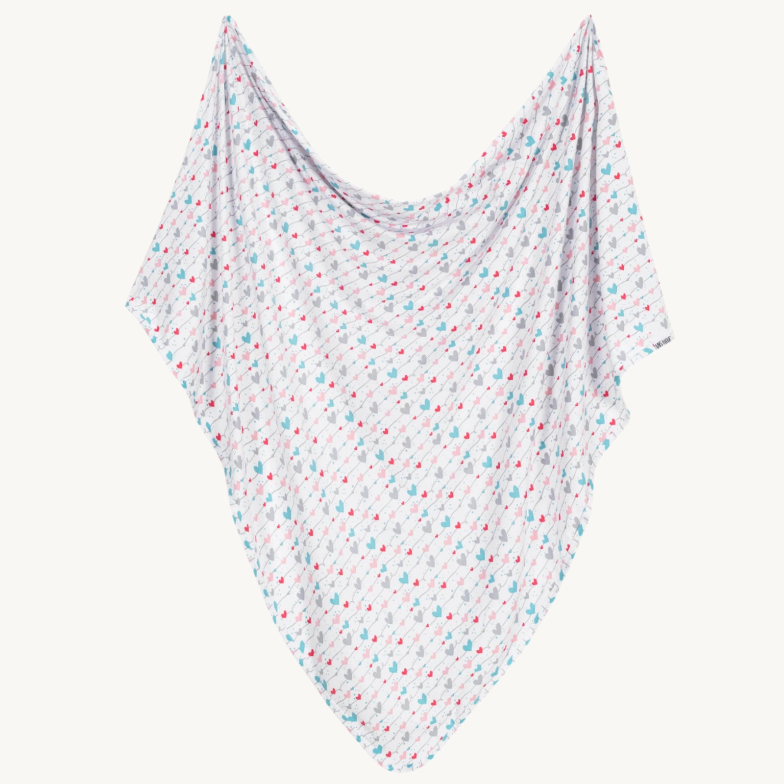 White baby blanket with colorful heart pattern on a white background
