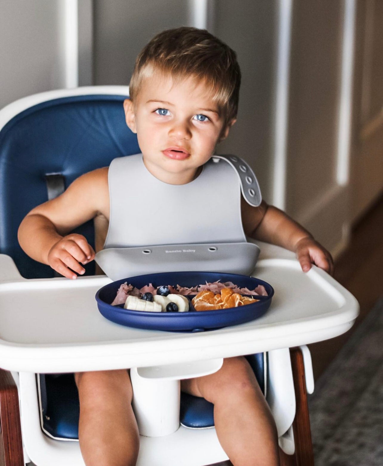 Bazzle Baby Anchor Silicone Plate in navy. Suctions to flat surfaces to not fall or slip.
